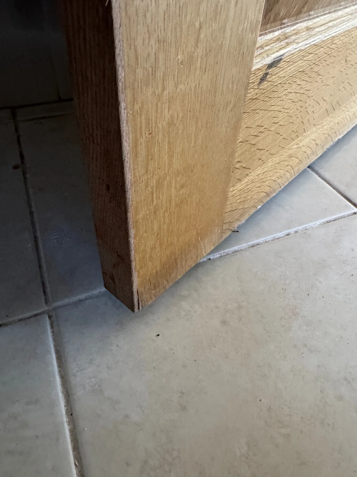 Swollen and damaged material along the lower edge of a timber door.